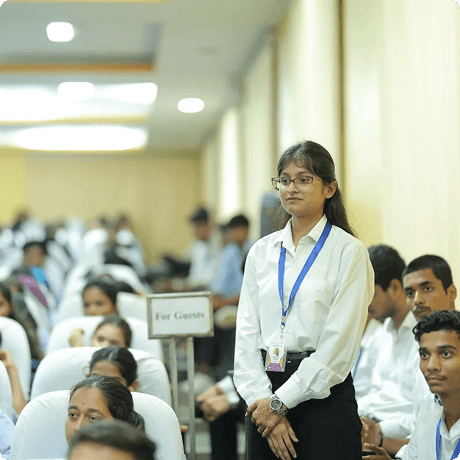 Student standing in a university hall